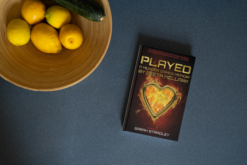 Book on a table next to a bowl of lemons