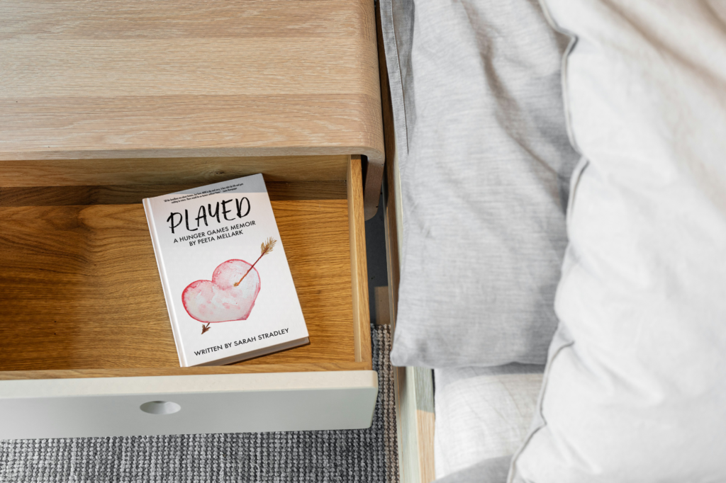 Book sitting in an open drawer of a bedside table